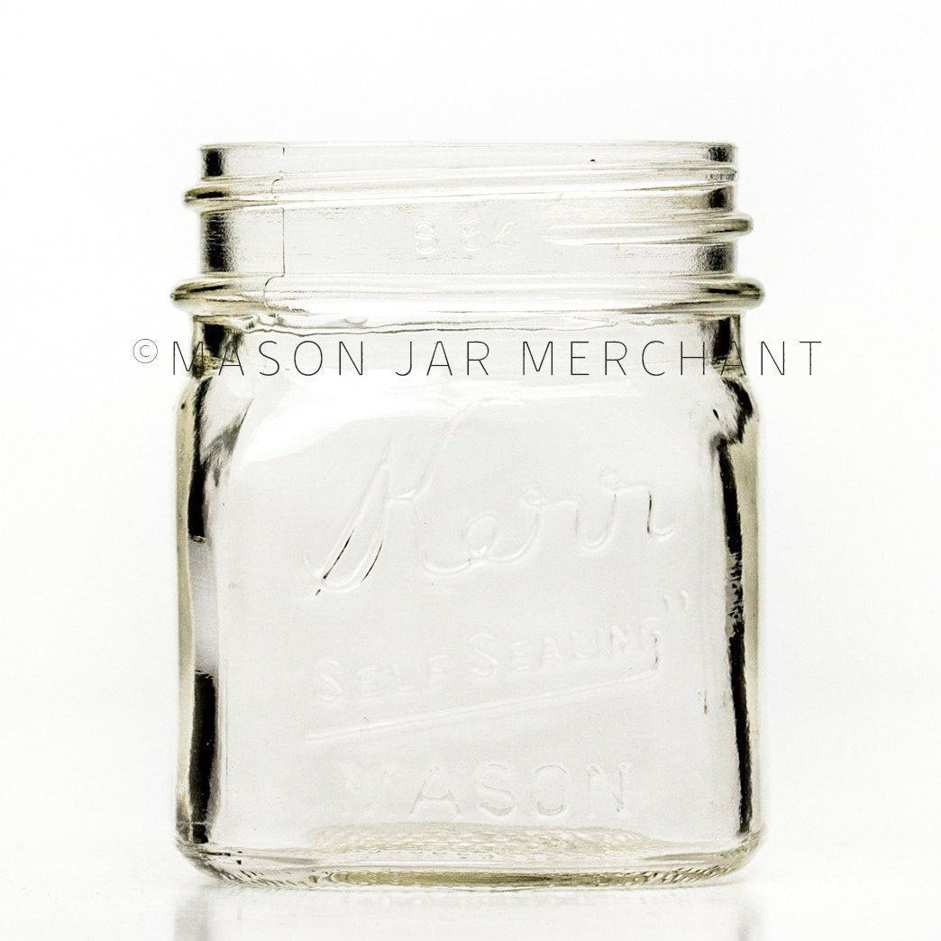 Regular mouth half-pint mason jar with square sides and Kerr self-sealing logo 