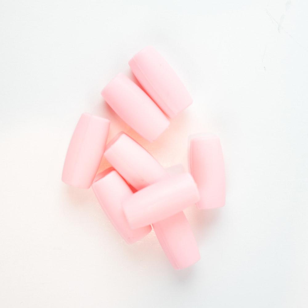 Pink silicone straw tips for stainless steel straws, set against a white background