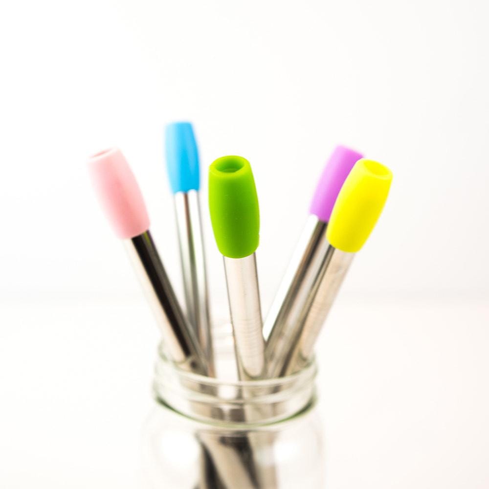 Close-up of stainless steel straws with colourful silicone straw tips against a white background 