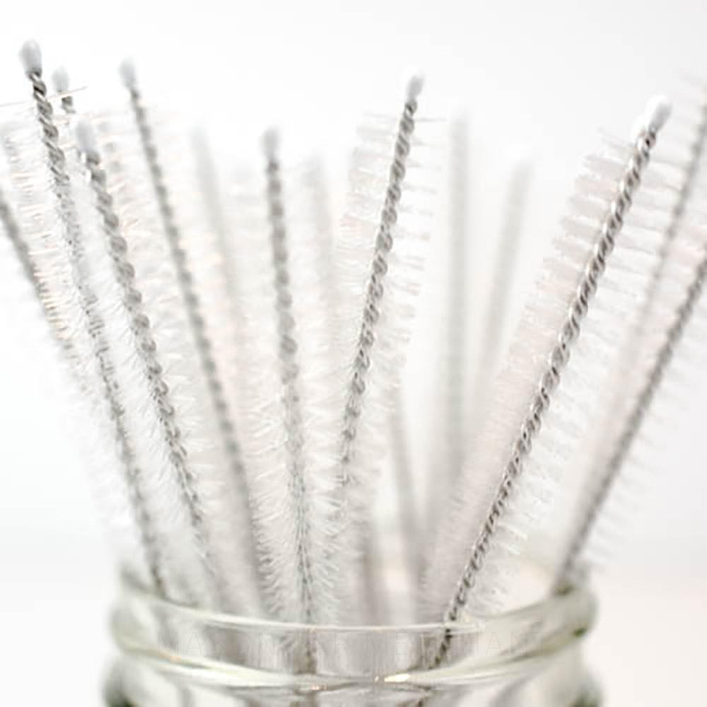 a close up of a bunch of straw cleaners in a glass mason jar