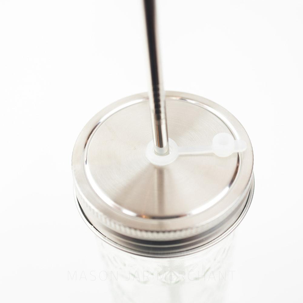 Close-up of a stainless steel mason jar drink lid with a stainless steel straw.