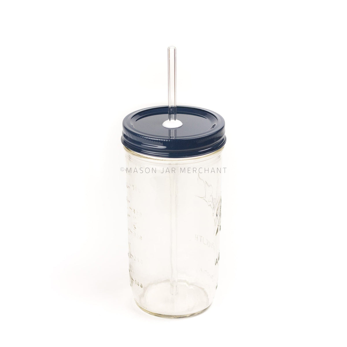 A 24 oz mason jar with a navy custom painted lid with a white silicone grommet and a glass straw, against a white backgroundClose-up of a 24 oz mason jar with a navy custom painted lid with a white silicone grommet and a glass straw, against a white background