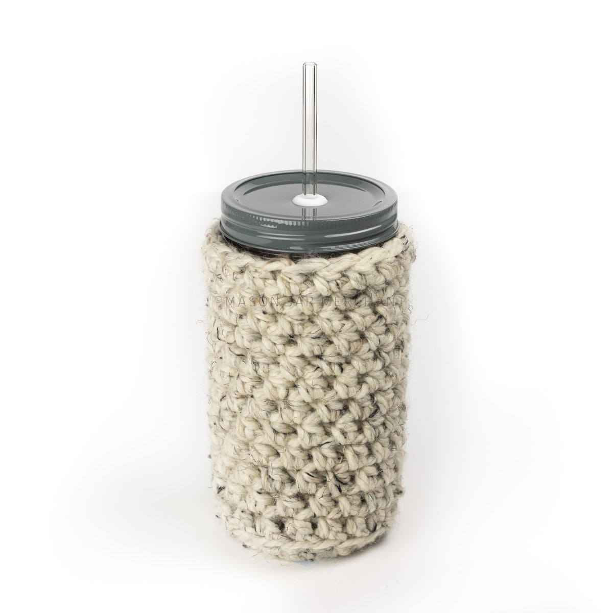 24 oz reusable glass mason jar tumbler with an all grey straw lid and a glass reusable straw. An off white knit cozy with flex of beige and black covers the jar