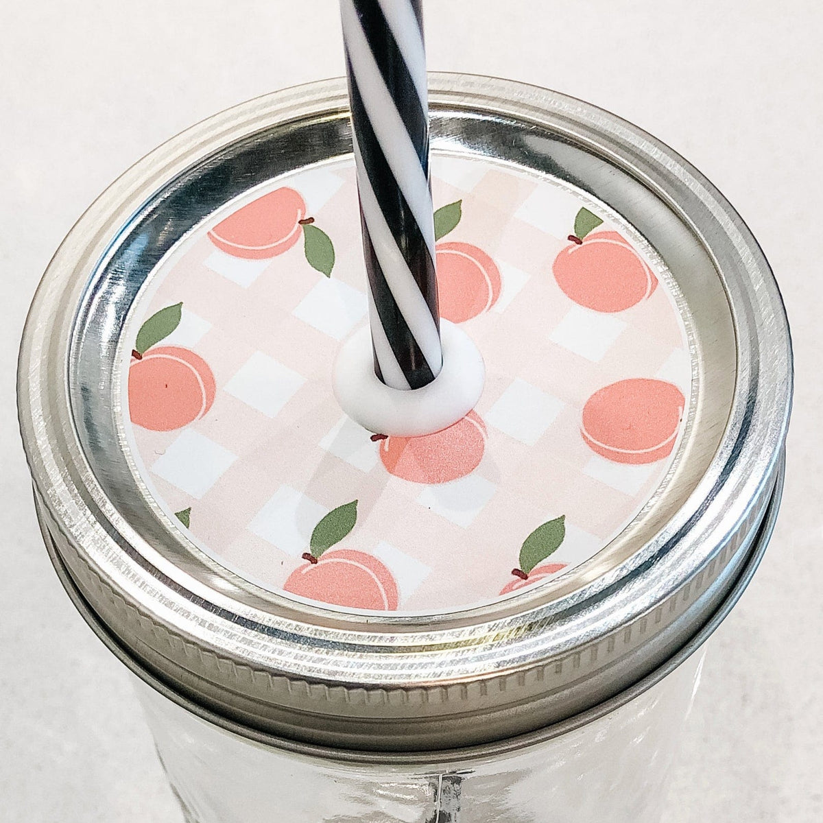 Close up photo of a peach fest mason jar straw lid