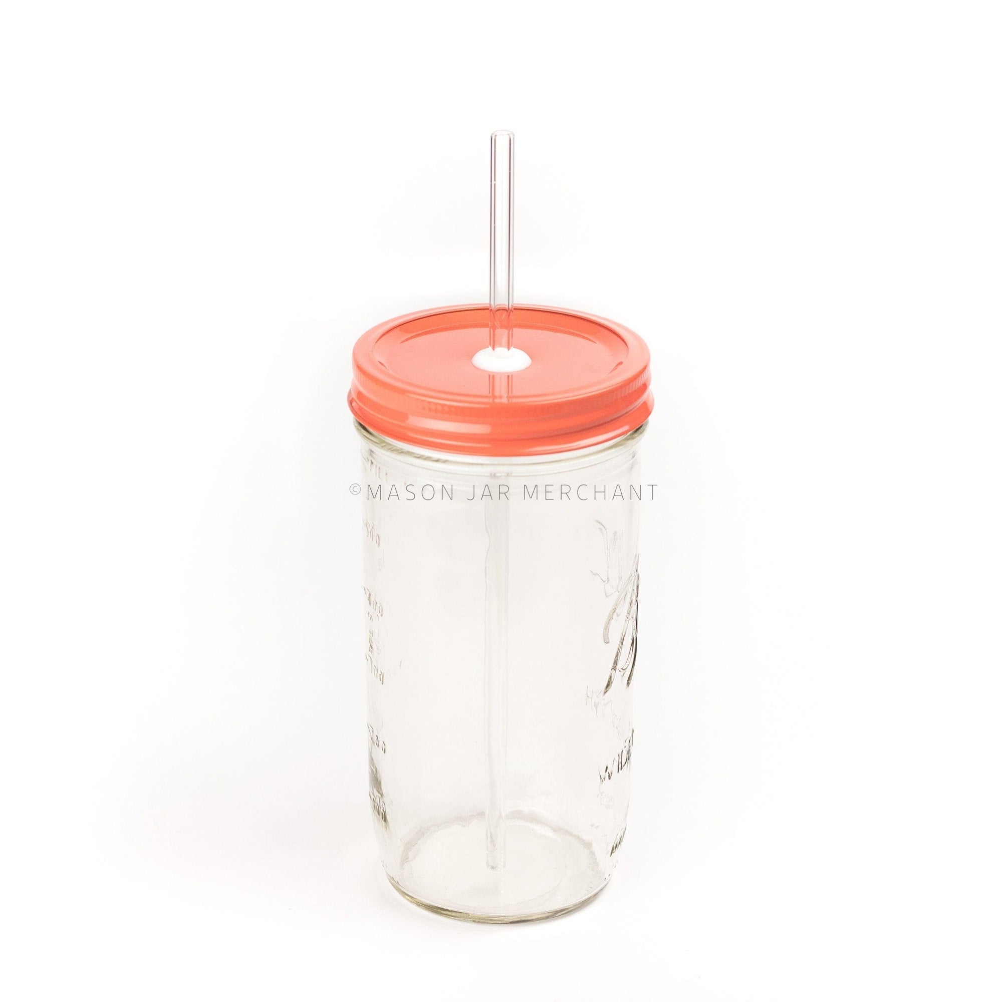 Close-up of a 24 oz mason jar with a coral coloured custom painted lid with a white silicone grommet and a glass straw, against a white background