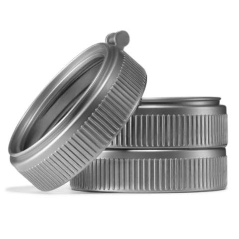 Close up of three mason jar plastic grey rings on a white background