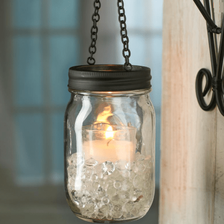 Black Rustic Candle Lantern Hanging Mason Jar Lid with candle and crystals inside.