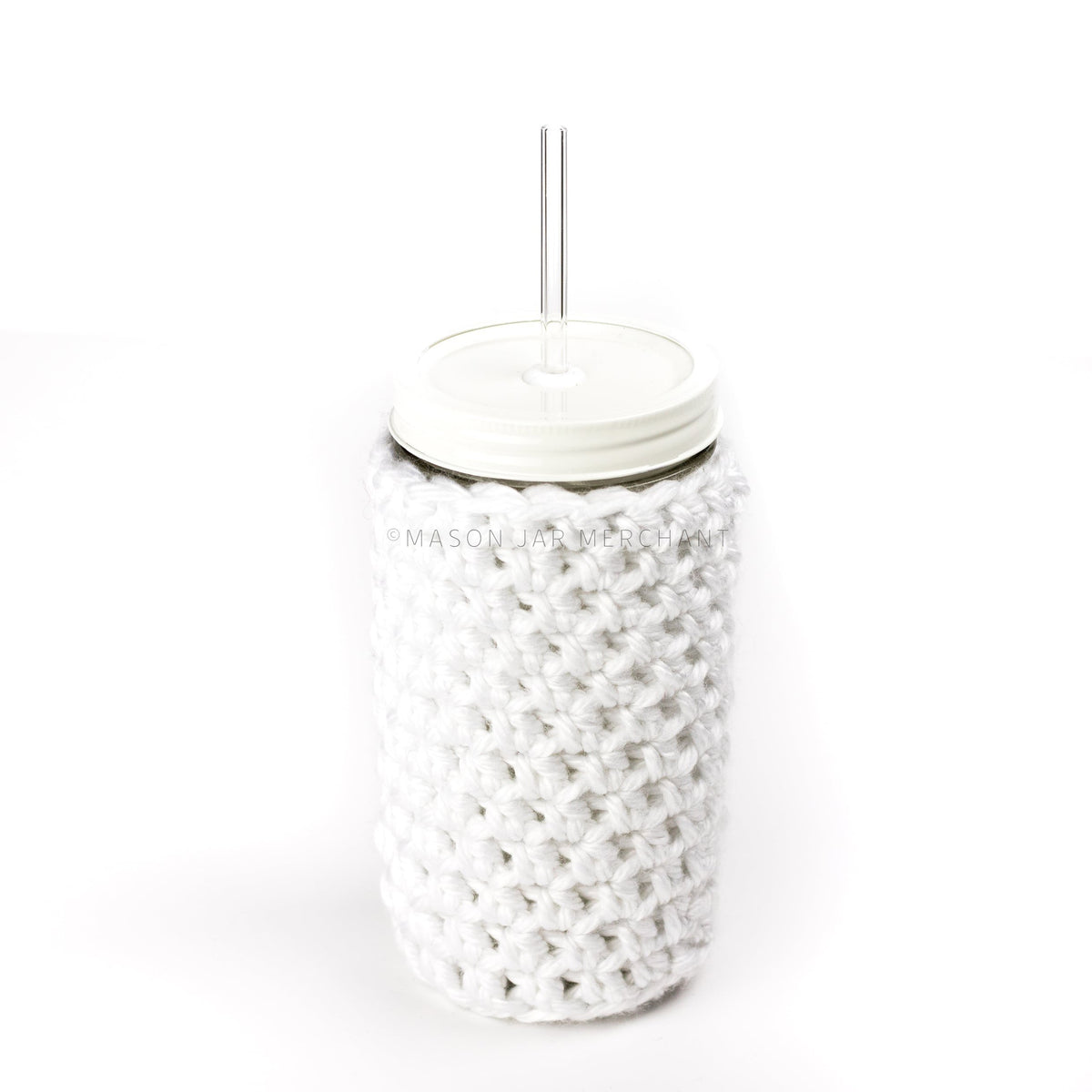 24 oz glass reusable mason jar tumbler with an all white straw lid and a glass reusable straw. A white knit cozy covers the jar