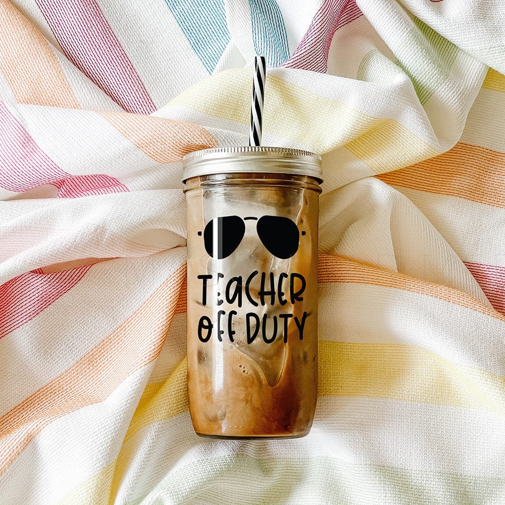 "Teacher Off Duty" print on tumbler with iced coffee with shades above print. Photographed against a striped picnic cloth..
