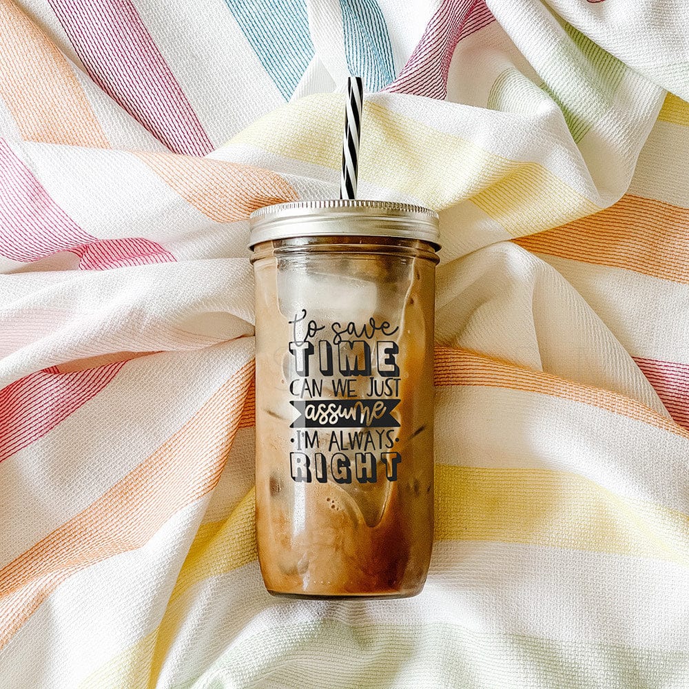 Tumbler with iced coffee with print that says "To save time, can just assume I'm always right." Photographed against a striped picnic cloth.