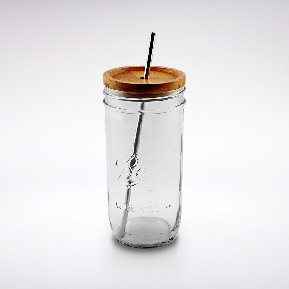 24 oz reusable glass mason jar tumbler with a dished wooden straw lid and a stainless steel silver reusable straw.