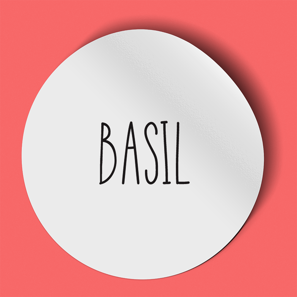 Waterproof label for crushed basil. Photographed against a red background.
