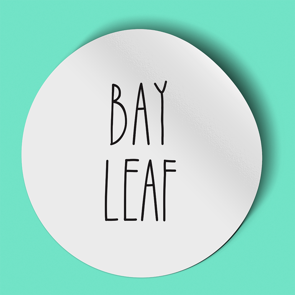 Waterproof label for bay leaf. Photographed against a light green background.