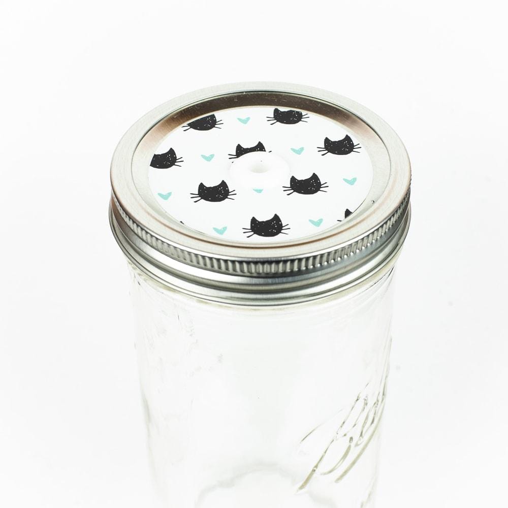 Patterned Black cats on white Mason Jar Straw Lid against a white background.