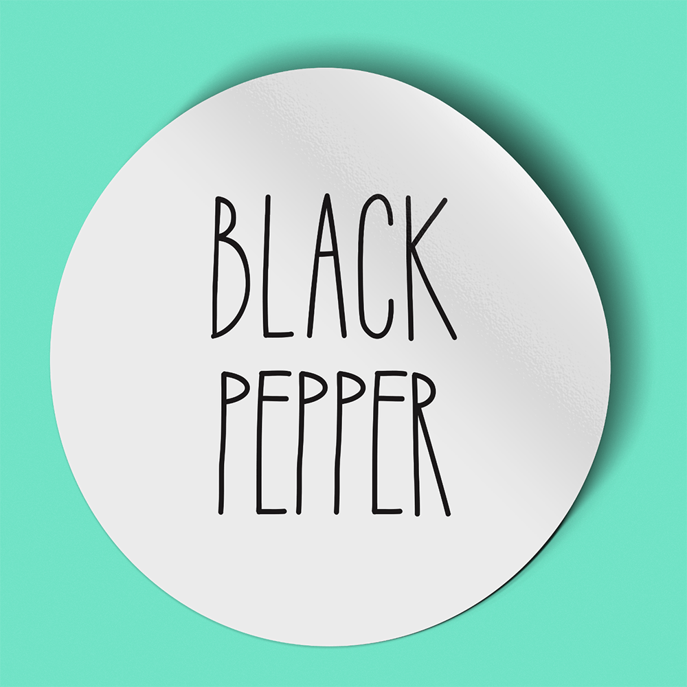 Waterproof label for black pepper. Photographed against a light green background.