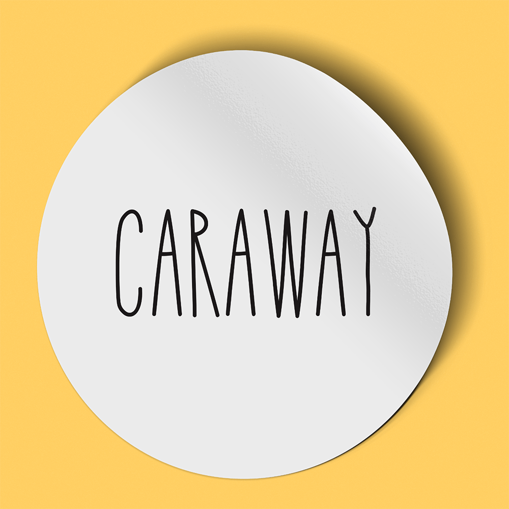 Waterproof label for caraway. Photographed against a yellow background.