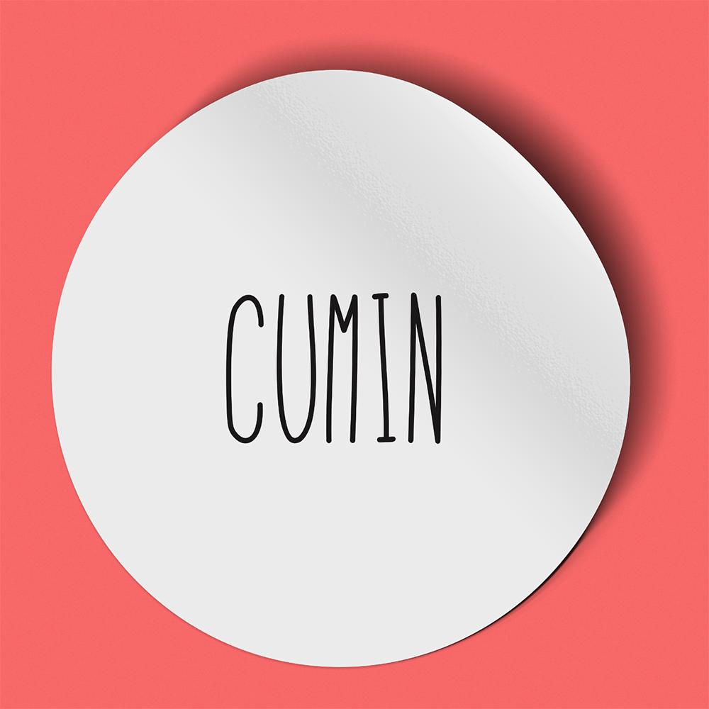 Waterproof label for cumin. Photographed against a red background.