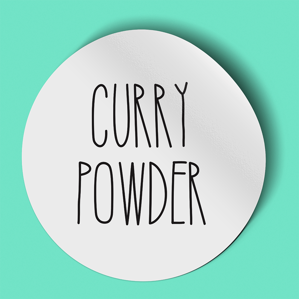 Waterproof label for curry powder. Photographed against a green background.