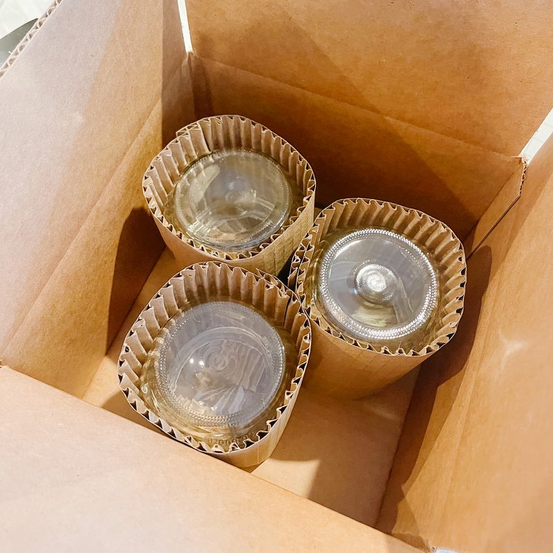 Wrapped jars standing in a box